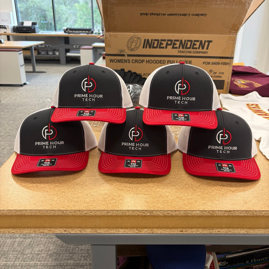 Black and red embroidered Prime Hour Tech employee hats